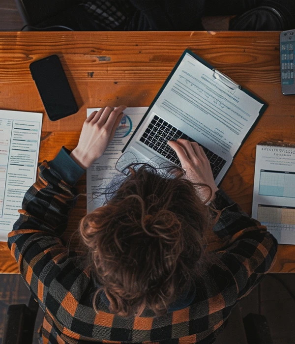 woman doing calculations at a desk for tax preperation